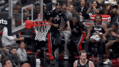 Basketball Players Celebrating Basket In Front Of Crowd GIF