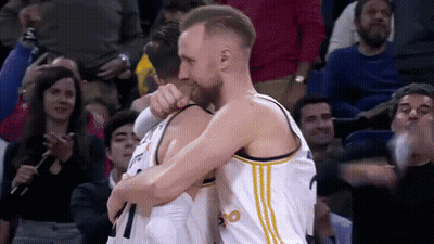 Basketball Players Hugging In Front Of Crowd GIF
