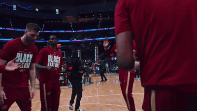 Basketball Players in Black History Shirts High Fiving
