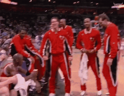 Basketball Players In Red And Black Uniforms On Court GIF
