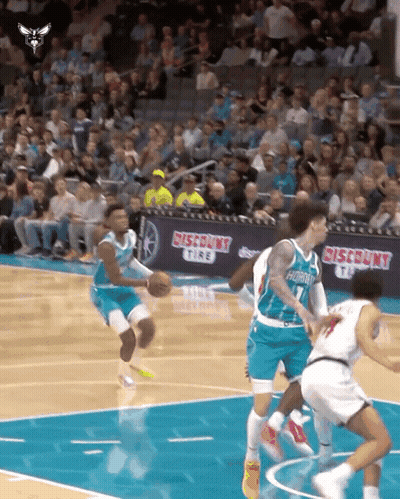 Basketball Players On A Court With A Discount Tire Banner In The Background GIF