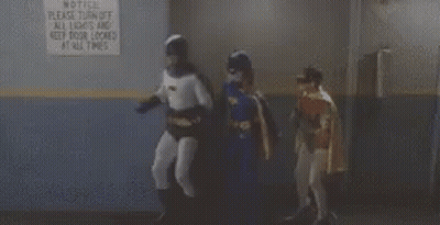 Batman And Batgirl Standing By All Lights And Door Locked Sign GIF
