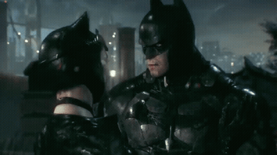 Batman And Catwoman Are Standing Next To Each Other And Looking At Each Other GIF