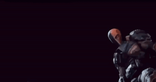 Batman And Deathstroke Are Standing Next To Each Other Holding Guns GIF