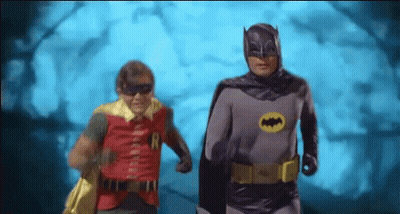 Batman And Robin Are Running In A Cave Together . GIF