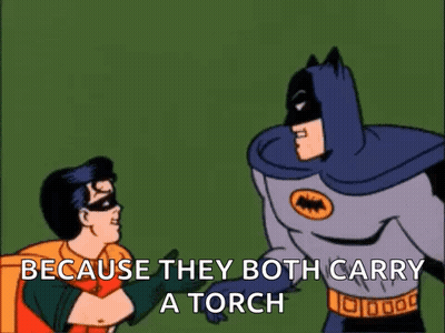 Batman And Robin Are Standing Next To Each Other And Batman Says " Because They Both Carry A Torch " GIF