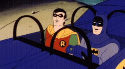 Batman And Robin In Car With R On Chests GIF