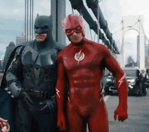 Batman And The Flash Are Posing For A Picture Together GIF