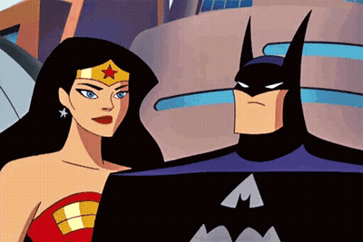 Batman And Wonder Woman Standing In Front Of Building GIF