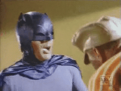 Batman Costume Man Next To Helmet Man GIF