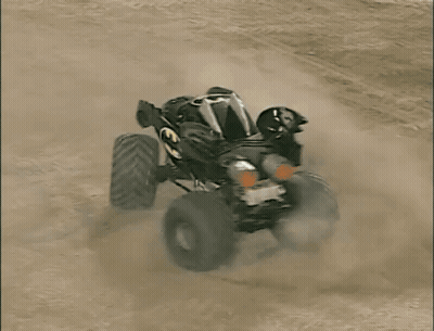 Batman Monster Truck Driving On Dirt Track GIF