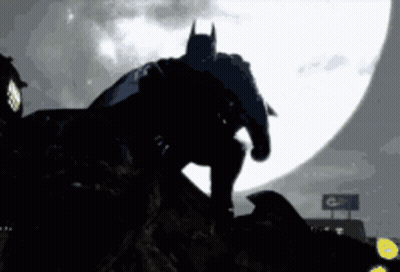 Batman Silhouette Standing on Rock in Front of Full Moon