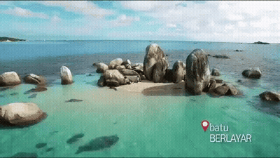 Batu Berlayar Is Written On The Bottom Of A Picture Of A Beach GIF