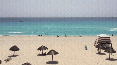 Beach With Umbrellas And Lifeguard Tower GIF