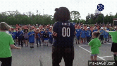 Bear Mascot With Number 00 In Front Of Children GIF