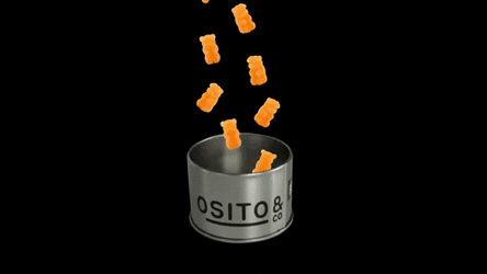 Bear Shaped Orange Gummies Falling Into Can GIF