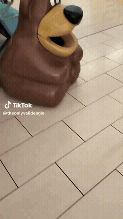 Bear Statue Sitting On Tiled Floor GIF
