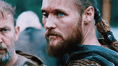 Bearded Blue-Eyed Man Next To Ponytailed Man GIF