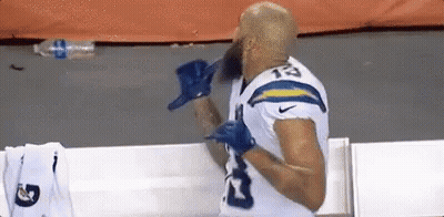 Bearded Football Player In Locker Room With Gloves GIF