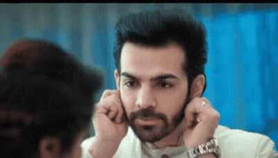 Bearded Man Adjusting Earring While Woman Looks On GIF
