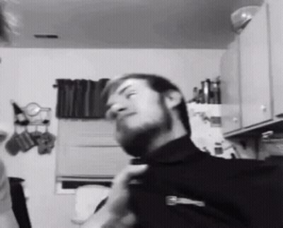 Bearded Man Adjusting Tie in Kitchen