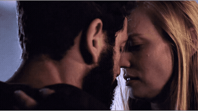 Bearded Man And Blonde Woman Locking Eyes GIF