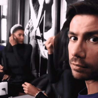 Bearded Man At Camera With Woman Fixing Hair GIF