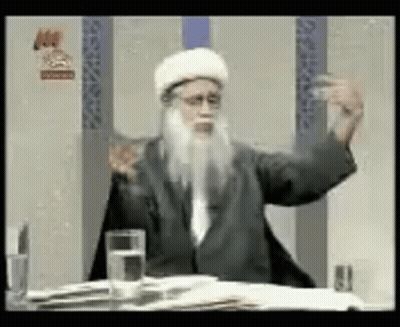 Bearded Man At Table With Water And Book GIF