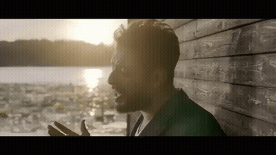 Bearded Man By Wooden Wall Near Water GIF