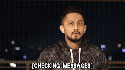 Bearded Man Checking Messages With Headphones GIF