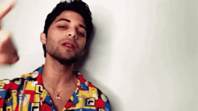 Bearded Man Colorful Shirt And Necklace GIF