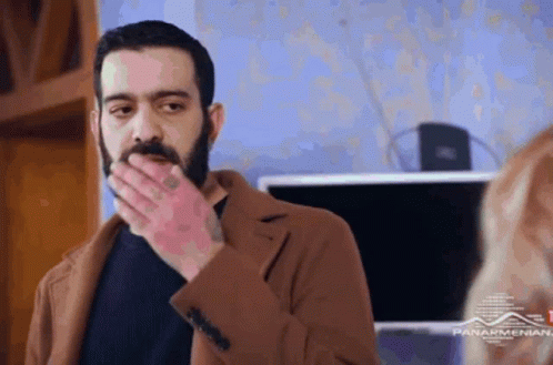 Bearded Man Covering Mouth GIF