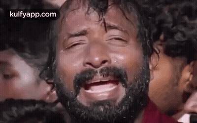 Bearded Man Crying Eyes Closed In Front Of Crowd GIF