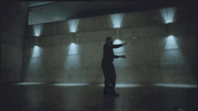 Bearded Man Dancing in Dark Room