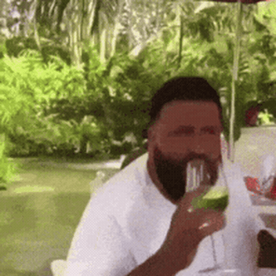 Bearded Man Drinking At Table GIF