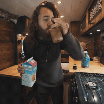 Bearded Man Drinking From Mason Jar Holding Almond Milk GIF
