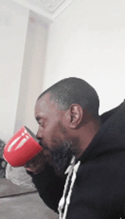 Bearded Man Drinking From Red Coffee Mug GIF