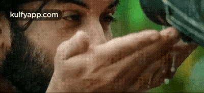 Bearded Man Drinking Water From Container GIF