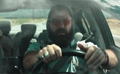Bearded Man Driving Car With Napkin On Face GIF