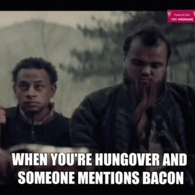 Bearded Man Eating Bacon Watched By Man GIF