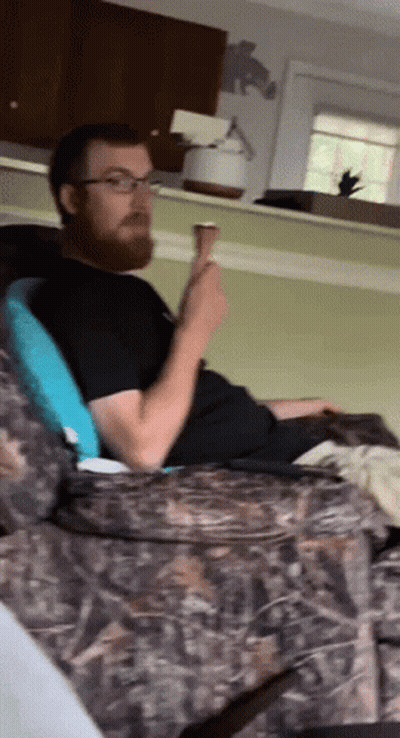 Bearded Man Eating In Chair GIF