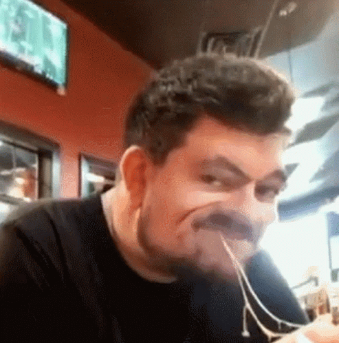 Bearded Man Eating Spaghetti Making Face GIF