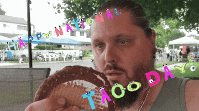 Bearded Man Eating Taco With National Taco Day Banner GIF