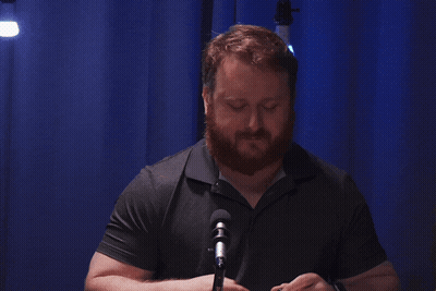 Bearded Man Gesturing At Microphone GIF