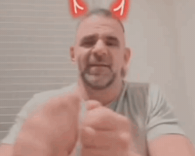 Bearded Man Giving Middle Finger In Bunny Ears GIF