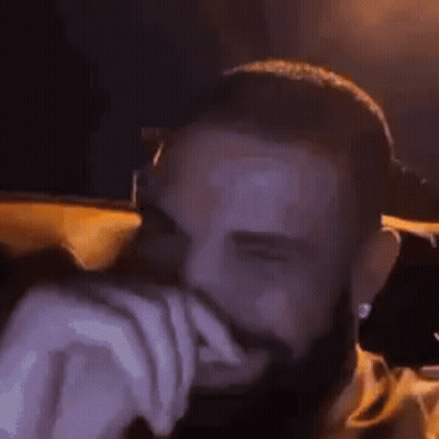 Bearded Man Hands On Face Dark Room GIF
