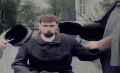 Bearded Man Held By Two Men In Wheelchair GIF