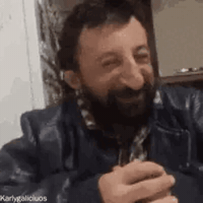Bearded Man Holding Beer At Table GIF