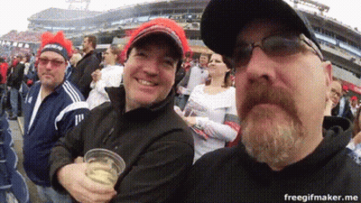 Bearded Man Holding Beer In Front Of Crowd GIF