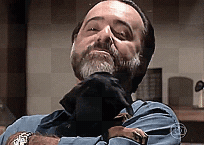 Bearded Man Holding Black Dog GIF